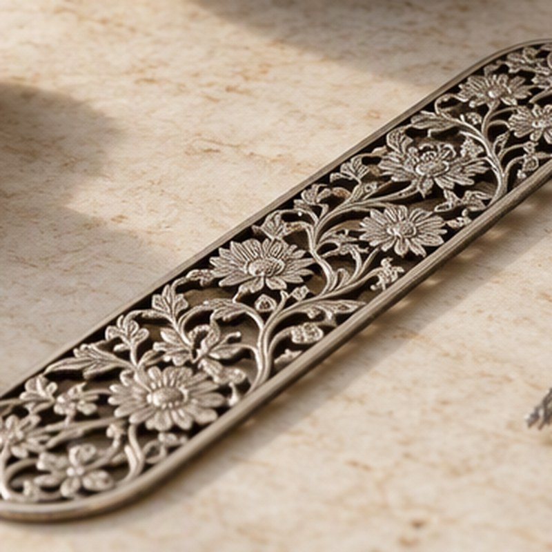 A silver filigree bookmark with a tassel
